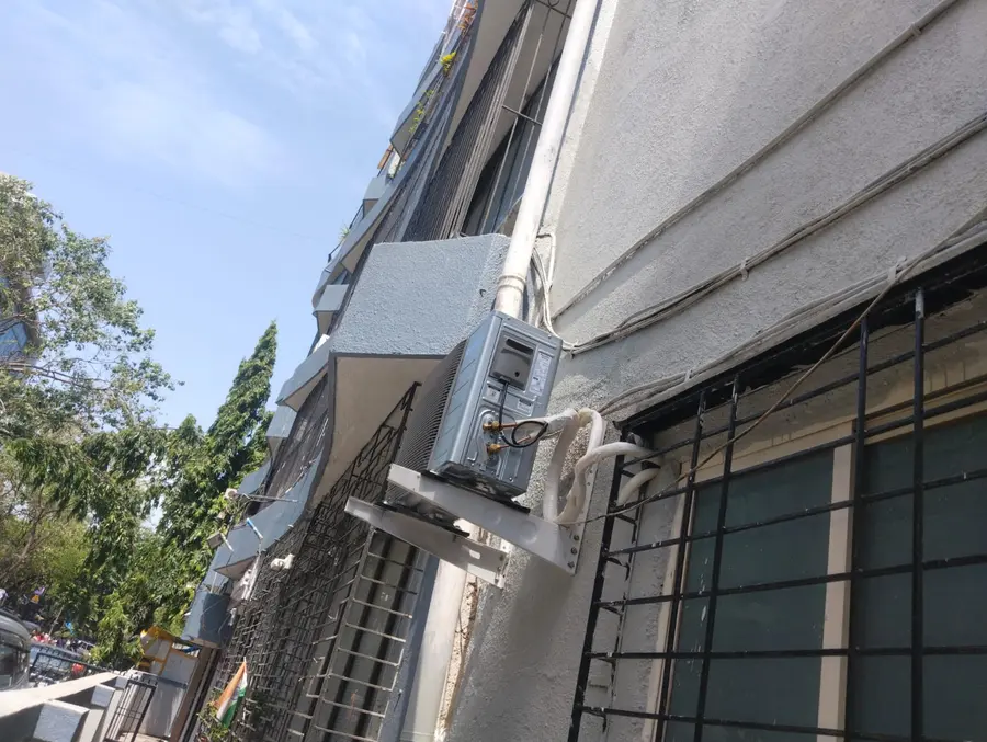 Outdoor condenser unit mounted on a building facade