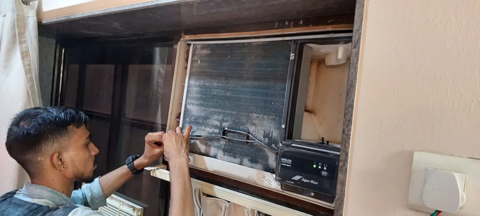 Technician repairing and cleaning an air conditioning unit coil